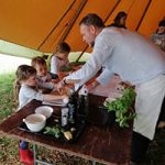 Man helping children with food preparation
