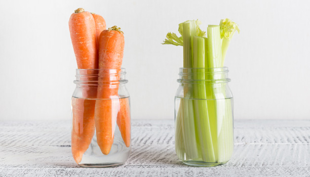 Fresh carrot and celery in mason jar with water