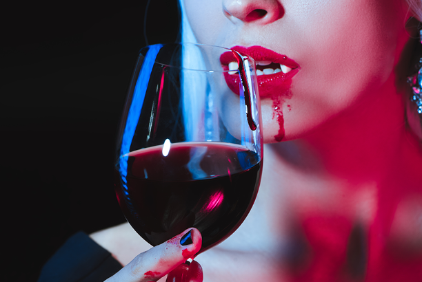 Vampire drinking red wine