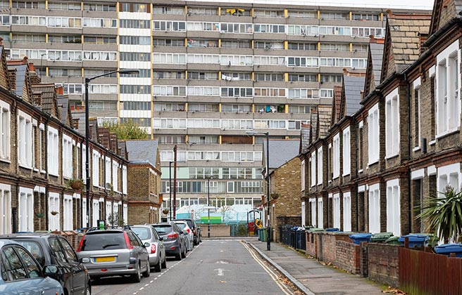A deprived area with poor housing and tower blocks