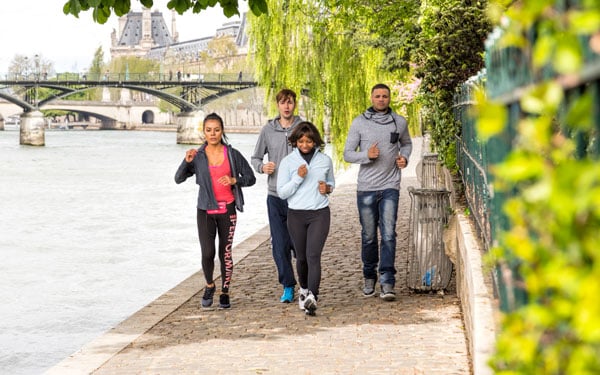 People jog along the Seine, Paris, France