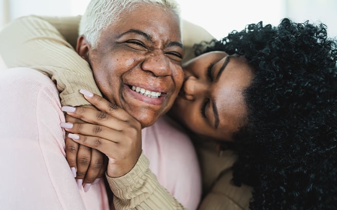 Two women embracing each other