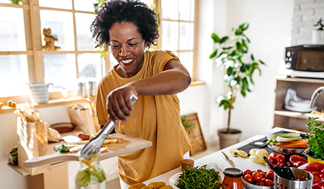A woman cooking with vegetables