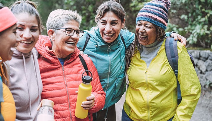 A group of women hugging on a walk