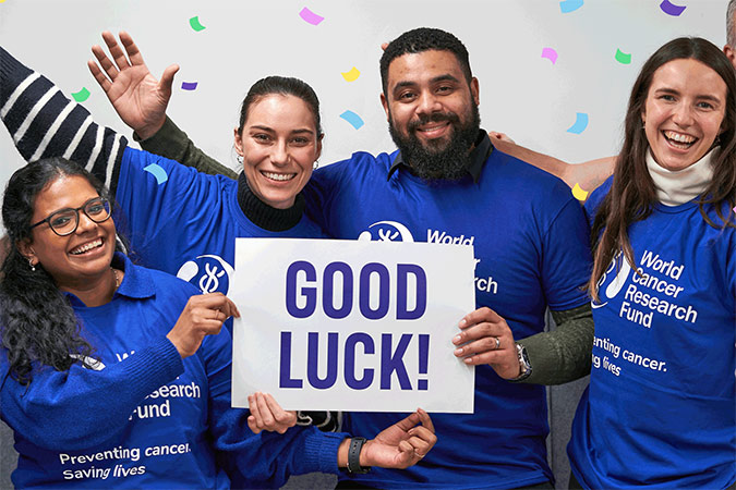 A group of WCRF employees saying good luck