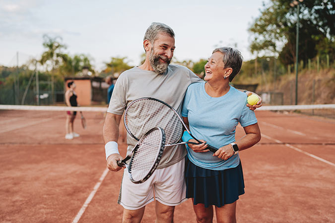 An older couple playing tennis