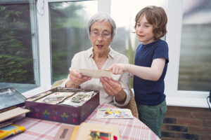 Grandmother and grandson looking through old photographs