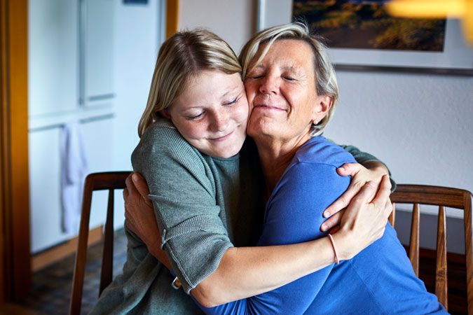 Grand-daughter and grandmother hugging