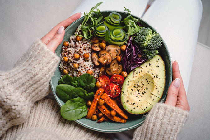 A healthy budda bowl, full of rice and fresh vegetables