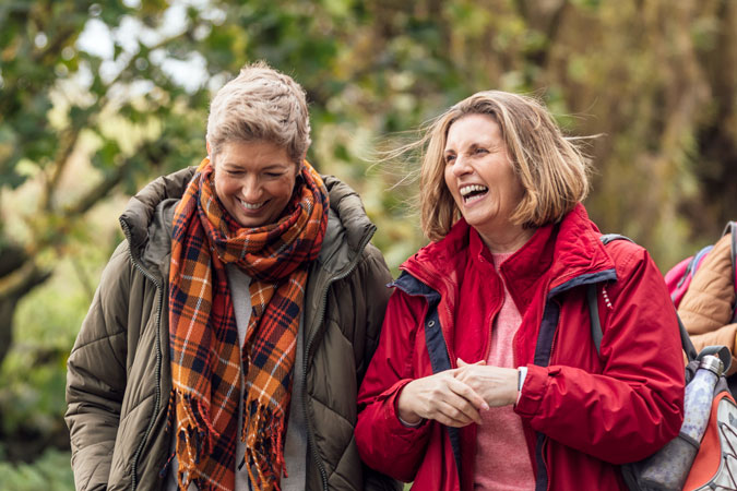 Two women laughing outside