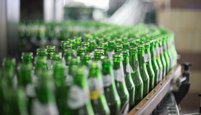 Beer bottles about to be filled on a production line