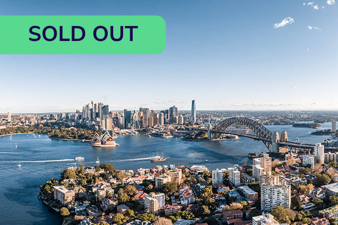 Aerial view of Sydney Harbour with the Opera House and Harbour Bridge; a green SOLD OUT banner is in the top left corner.
