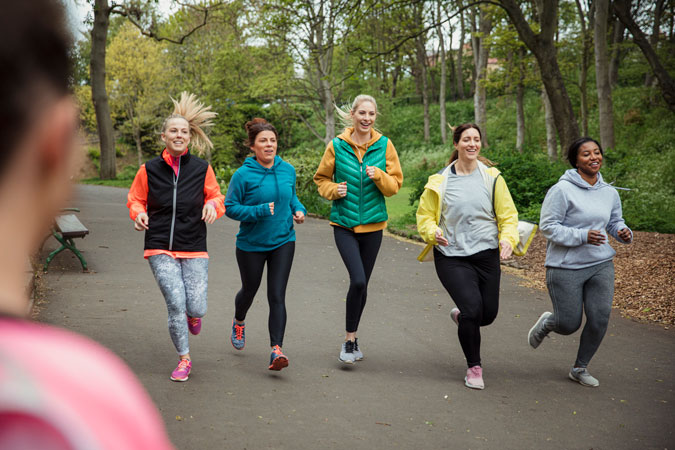 A group of women running through a wood