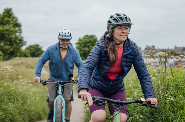 Man and woman out cycling through the countryside