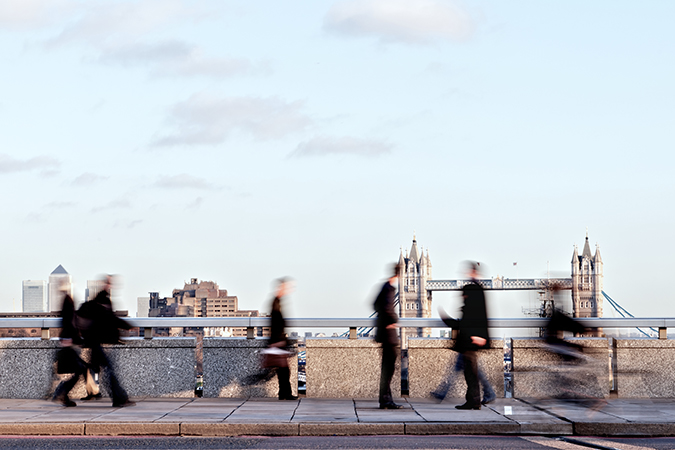 Business people walking across a bridge