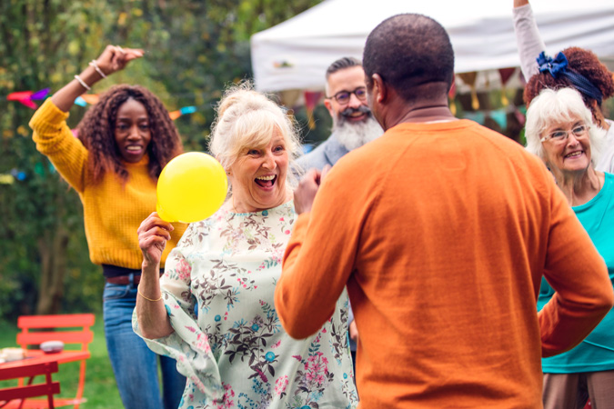 Older people dancing at a garden party