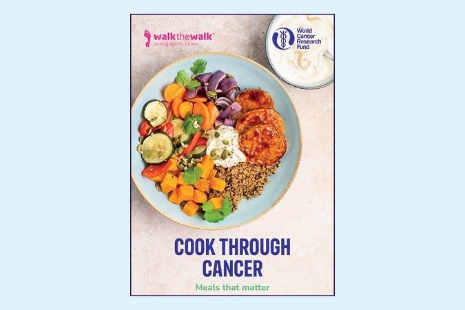 A cookbook cover titled Cook Through Cancer: Meals that matter featuring a colourful plate of healthy food with vegetables, grains, herbs, and dip. Logos for Walk the Walk and World Cancer Research Fund are shown at the top.