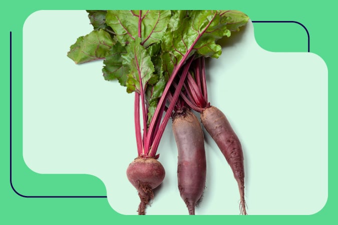 Three whole beetroot with leafy green tops lie side by side on a light green background with rounded geometric shapes, offering a vibrant visual for cancer prevention resources for health professionals.