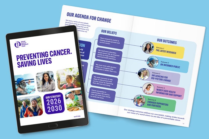 A tablet displays a cover reading Preventing Cancer. Saving Lives and a timeline UK Strategy 2026–2030. Next to it, an open booklet shows an agenda with colourful sections for beliefs and outcomes, including photos of diverse people.