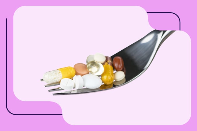 A fork holding various colourful pills and capsules against a pink background with graphic shapes, illustrating the concepts discussed in the Rethinking Healthy Eating webinar for health professionals.