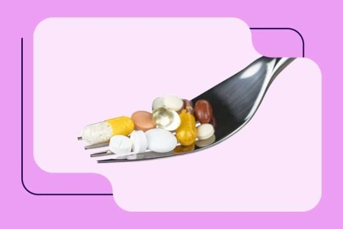 A metal fork holds an assortment of colourful pills and capsules against a vibrant pink and purple background, evoking the dynamic learning in live and on-demand webinars for health professionals.