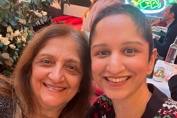 Two women posing for a smiling selfie together, taken during a breast cancer scare.