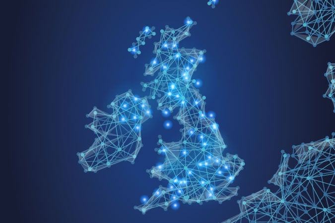 Digital map of the United Kingdom and Ireland rendered in a blue glowing network of interconnected nodes and lines displaying cancer statistics.